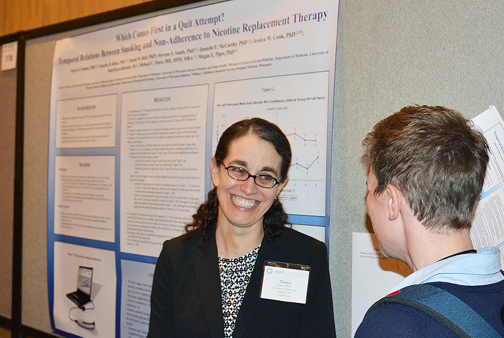 Dr. Tanya Schlam (left) enjoys a bit of levity during her poster session with a fellow SRNT attendee. 