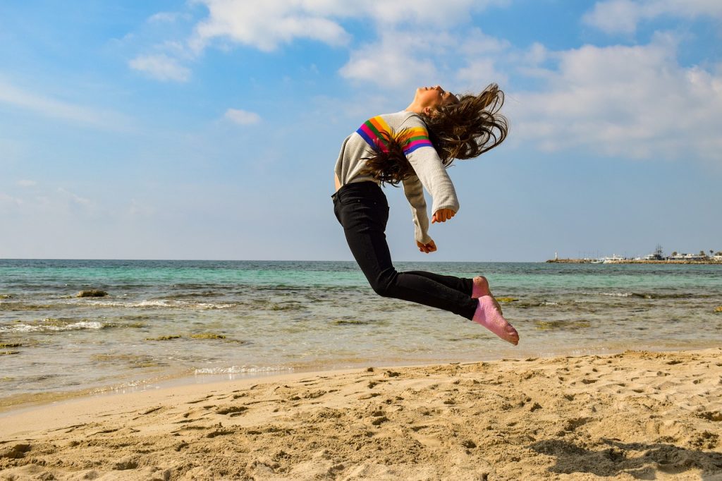 Teenager jumps on beach