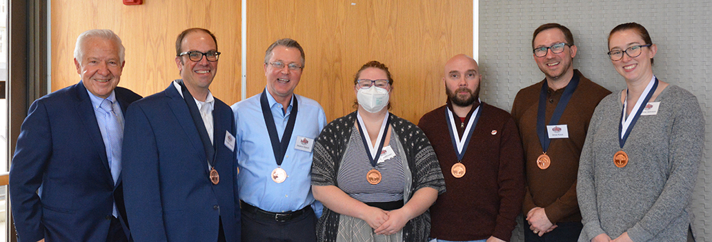 From left: Dr. Michael Fiore celebrated colleagues who earned 5-year service medals: Dr. Tom Piasecki, Dr. Marlon Mundt, Julia Matthews, Jonah Stankovsky, Dr. Jesse Kaye, and Dr. Adrienne Johnson. 