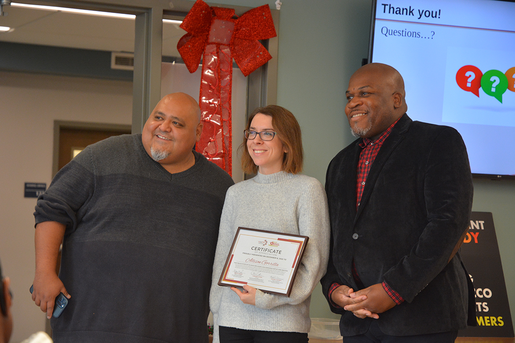 Edgar Mendez (left) and Michael Campbell present an advocacy award to UW-CTRI Outreach Specialist Allie Gorrilla.