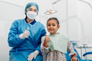 Dentist and patient give thumbs up
